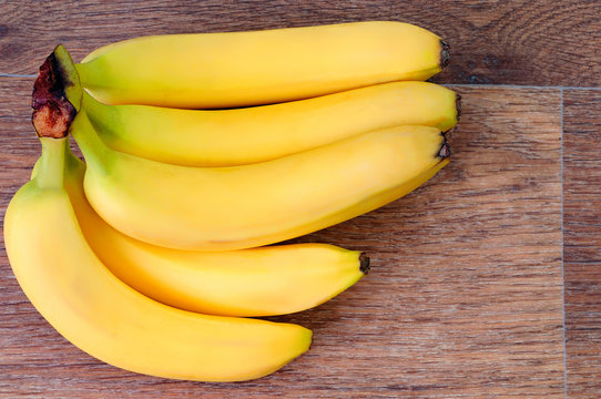 bunch Bananas on wooden table background top view