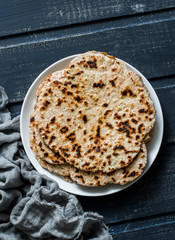 Gluten free healthy diet flatbreads on dark background, top view