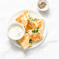 Fried stuffed chickpeas, spinach, leek and mozzarella rolls on a light background, top view. Delicious snack, appetizers, tapas or breakfast