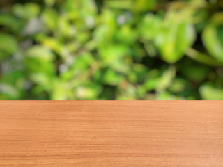 Wooden top table and green background with copy space for your text