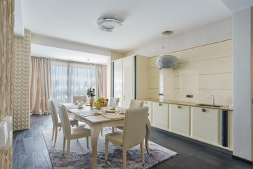 Interior of light spacious kitchen with served table in a luxury villa