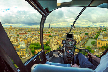 Helicopter cockpit flying on Notre Dame skyline of Paris, French capital, Europe. Scenic flight over Paris cityscape.