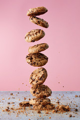 Chocolate chip cookies falling in stack - obrazy, fototapety, plakaty