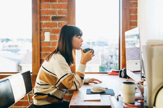 Woman sitting at desk and using computer