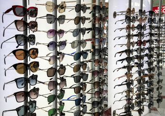 A Many Sunglasses on a shop window