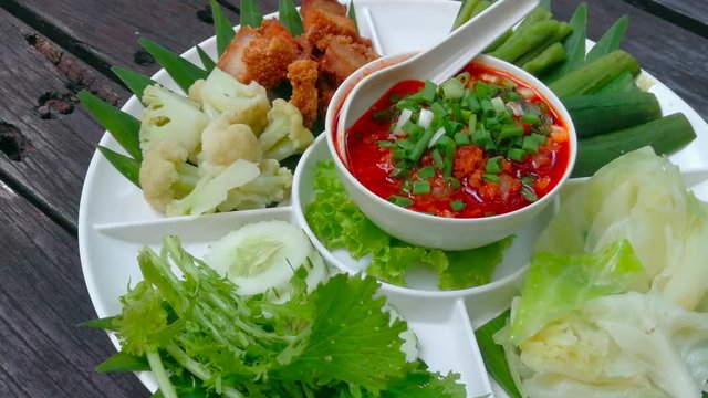 Thai cuisine nam prik or chili paste mixes with shrimp serves with various vegetables. shrimp Chili Sauce and thai vegetables on wooden table