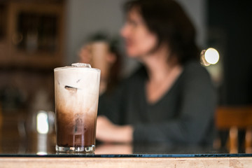 Drinking iced coffee at the table with my mom