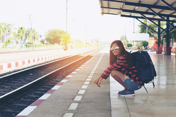 Tourists women are waiting for the train alone. Travel concept.