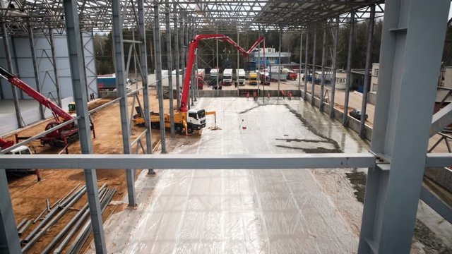 Crane at the construction site. Construction of a new warehouse quadcopter view. Logistics centre