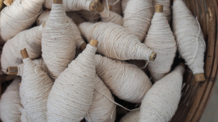 Balls of cotton yarn in a basket, color natural dyes handmade, soft focus and vintage tone for...