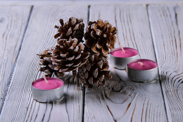 christmas still life with candle and pine cones