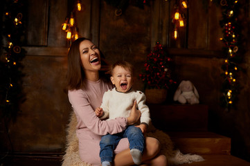 happy family mother and baby playing at home for Christmas