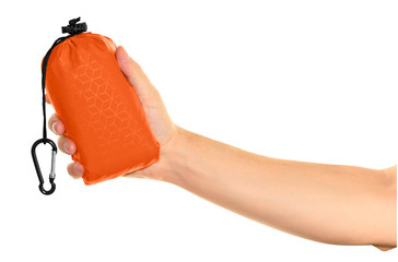 Very compact hand held orange nylon pocket blanket in a drawstring bag with a carabiner. Thin tarp...