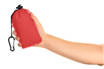 Very compact hand held red nylon pocket blanket in a drawstring bag with a carabiner. Thin tarp or...