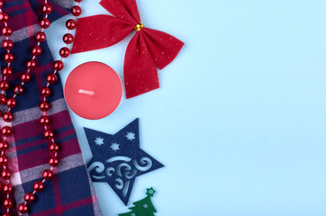 New Year composition with candles, star, cotton textile, ribbon and beads. Christmas concept background. Flat lay, top view of festive still life