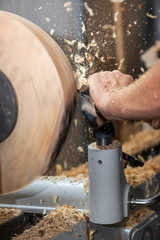 rotating piece of wood and fyling sawdust while making a bowl