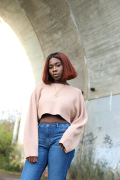 Portrait of woman standing under bridge
