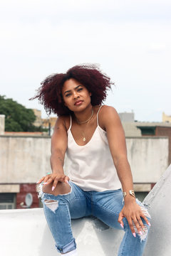 Portrait of woman sitting on roof