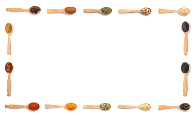 Frame of wooden spoons with different spices and herbs on white background, top view. Large collection with space for design
