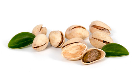 pistachios with leaves on a white background