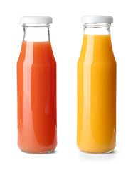 Set with glass bottles of different juices on white background