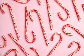 Flat lay composition with tasty candy canes on color background