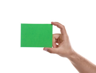 Football referee holding green card on white background, closeup