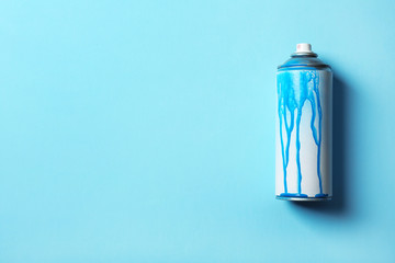 Used can of spray paint on color background, top view. Space for text