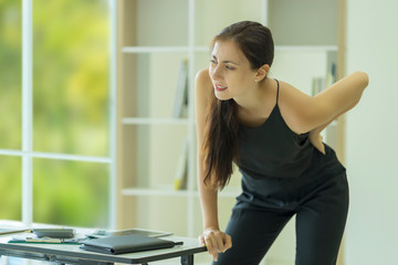 Businesswoman suffering from back and waist pain at office, Office syndrome. Health concept.