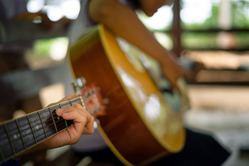 Secondary school students are learning how to play guitar in sch