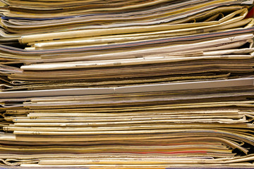 closeup of old newspapers and magazines, stack, side view,
