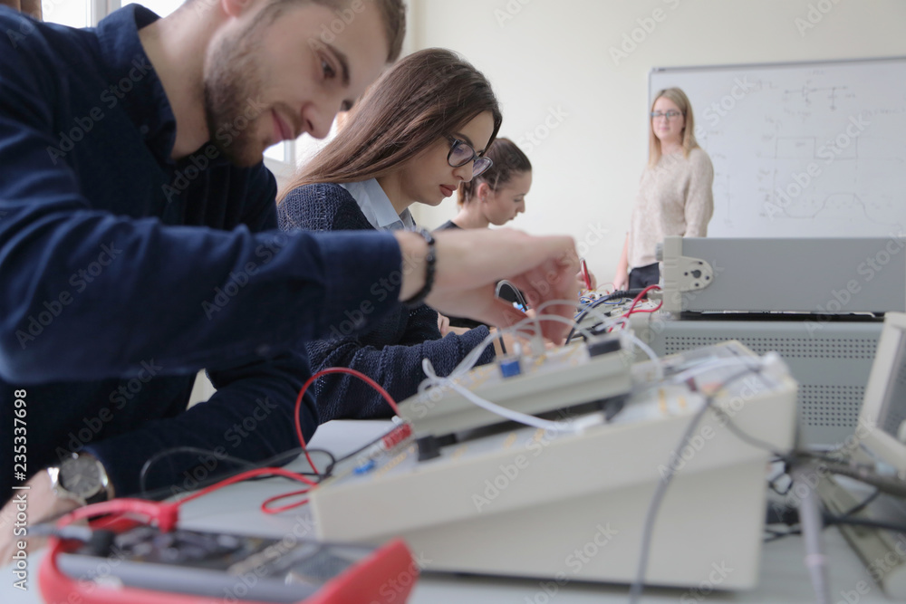 Wall mural group of young students in technical vocational training with teacher, the lesson in technical colle