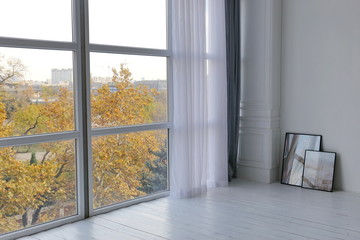 room of the luxury apartment with white walls and big windows