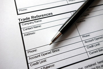 Trade references heading on business credit application form   with pen
