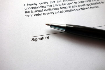 Space for signature on document and pen