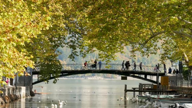 Time lapse of the bridge of love (in french "pont des amours"), a famous romantic and touristic place in the city of Annecy France. View on the canal du Vassé and the Annecy lake behind the bridge.