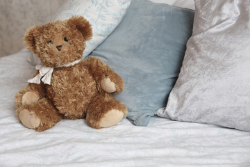  toy bear  sitting on the bed n the luxury apartments