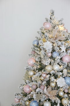 new year and Christmas tree with pink blue and white tiys under the instant snow