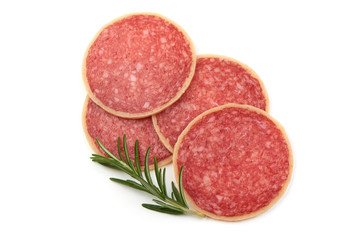 Salami with rosemary. Smoked sausage thinly sliced, isolated on white background. Top view.