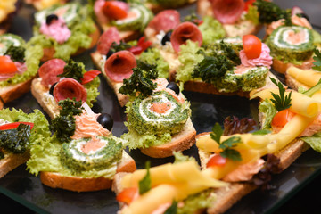 A lot of sandwiches on the epergne, sandwich buffet.