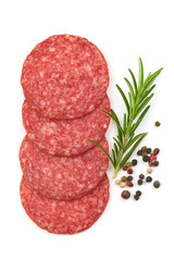 Winter Salami. Thin Sausage slices with rosemary and peppercorns, isolated on a white background. Top view.