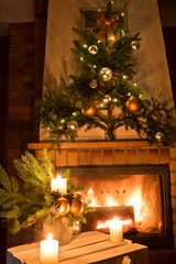 Christmas floral decoration in front of firepace.