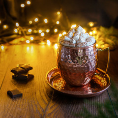 Christmas card. Christmas picture for design. The hand-made marshmallow lies in the light of the lanterns background. Food concept.