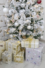 Christmas tree with gift boxes in a white vintage Provence interior