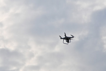 Drone flying on the sky background.