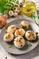 Meat stuffed potato dumplings with fried onion  and greaves on top