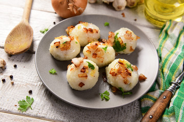 Meat stuffed potato dumplings with fried onion  and greaves on top