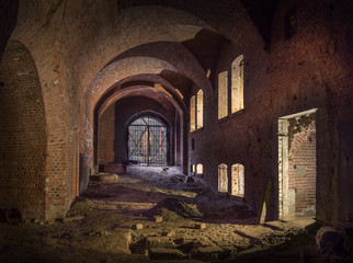 Fototapeta na wymiar abandoned underground brick corridor with windows illuminated by counter light.