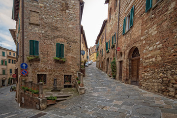 Fototapeta na wymiar Street and houses in Montepulciano. Characteristic street and houses in small historic medieval village Montepulciano, Tuscany, Italy