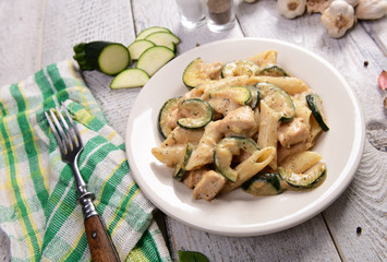 Penne pasta witch chicken and zucchini in cheese sauce